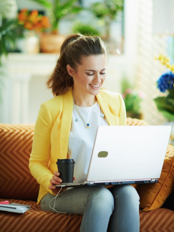 a woman smiles while watching her website